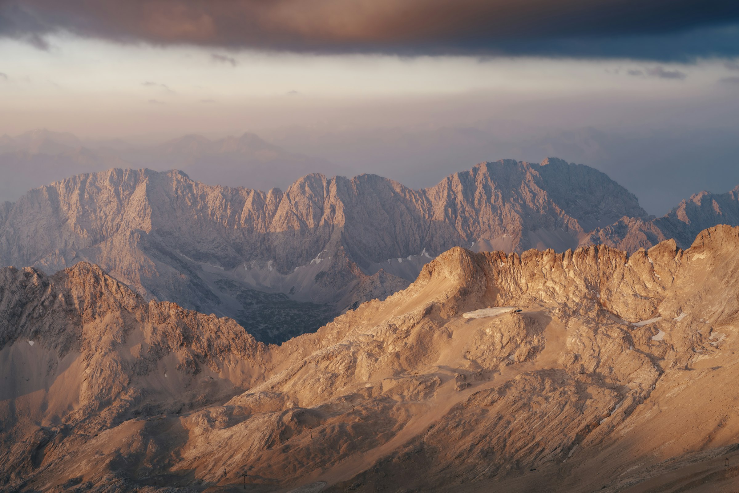 Golden alpine mountain peaks glowing at sunset