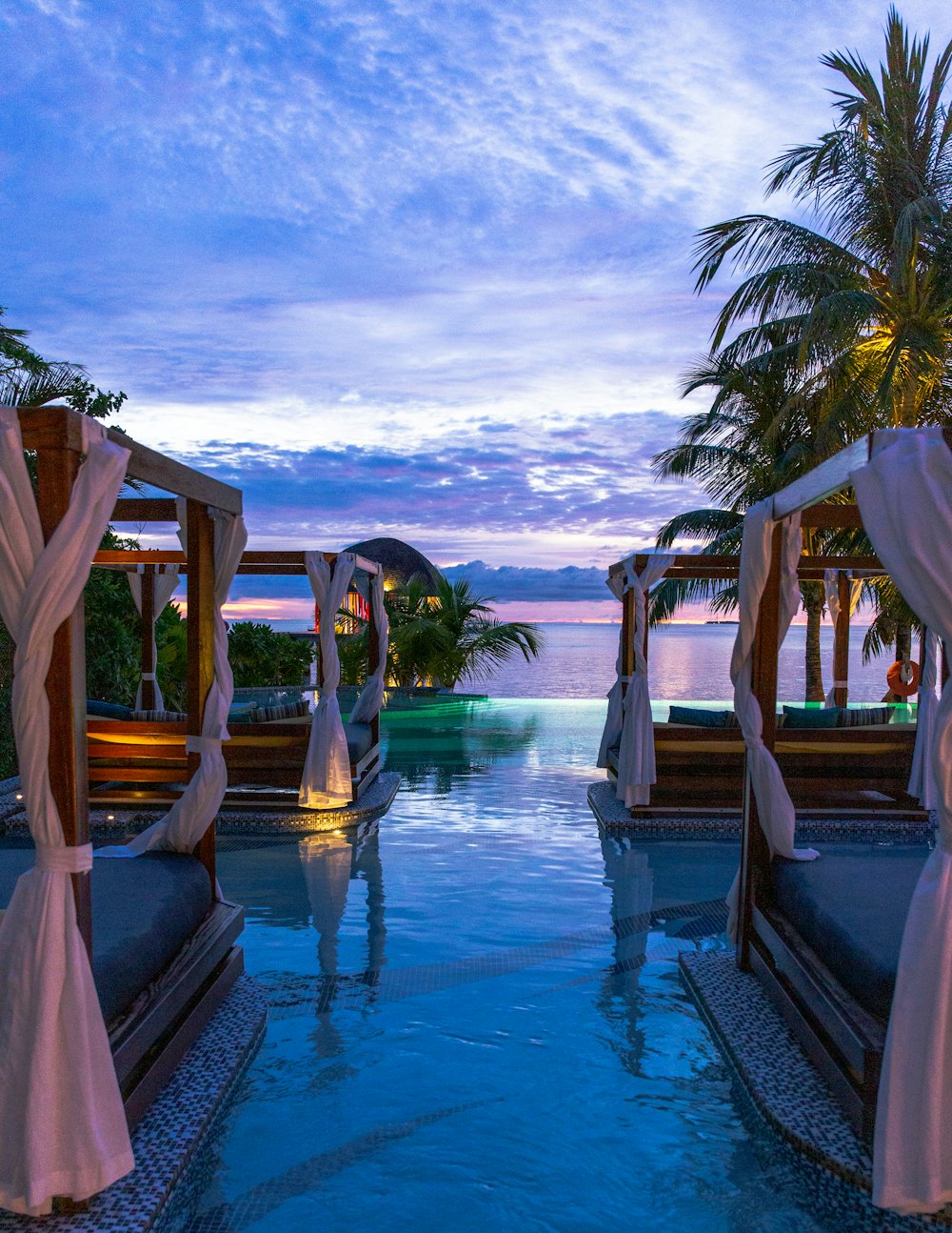 A poolside resort cabana at sunset